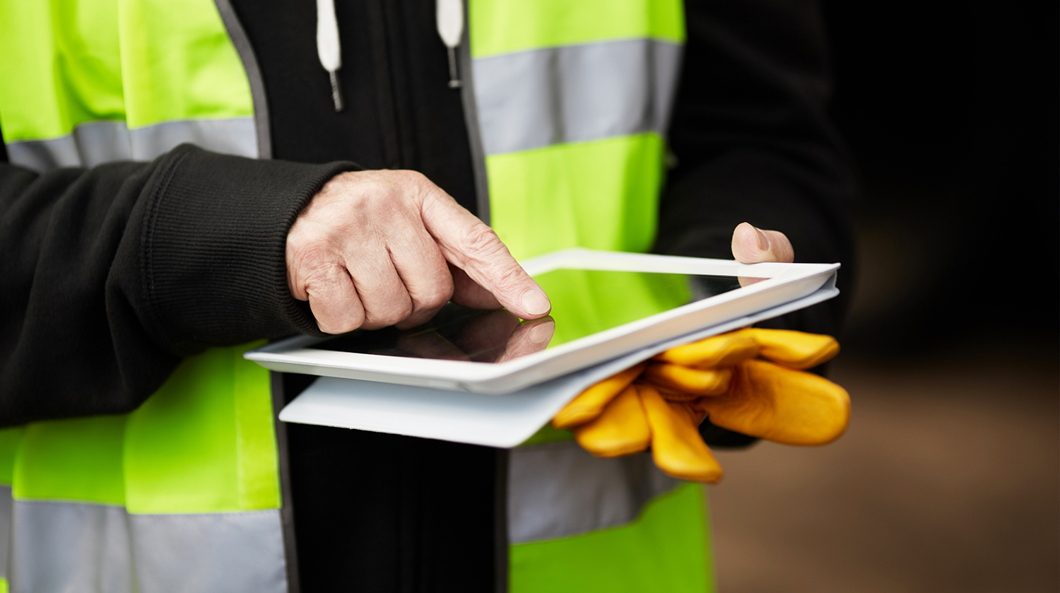 Person using ipad with PPE gear