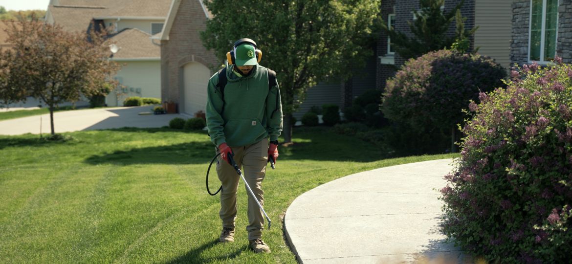 guy spraying grass